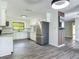 Open-concept kitchen with stainless steel fridge, white cabinets, and modern design at 43 Lake Court Loop, Ocala, FL 34472