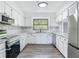 Bright kitchen with white cabinets, modern appliances, and marble countertops at 43 Lake Court Loop, Ocala, FL 34472