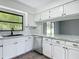 Modern kitchen featuring marble countertops, stainless steel appliances and ample cabinet space at 43 Lake Court Loop, Ocala, FL 34472