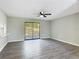 Spacious living room with modern ceiling fan, and slider to the backyard at 43 Lake Court Loop, Ocala, FL 34472