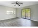 Open living room with modern ceiling fan, and slider to the backyard at 43 Lake Court Loop, Ocala, FL 34472