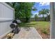 Fenced backyard with a grill, brick patio, and plenty of green space for outdoor activities at 4313 Gumbo Limbo Dr, Orlando, FL 32822