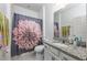 Bathroom with a floral shower curtain, granite countertops, a white sink and cabinets, and tile flooring at 4313 Gumbo Limbo Dr, Orlando, FL 32822