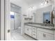 Bright bathroom featuring a double vanity with granite counters and a walk-in shower at 4313 Gumbo Limbo Dr, Orlando, FL 32822