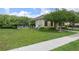 Exterior view of the community pool area with lush landscaping and a nearby building at 4313 Gumbo Limbo Dr, Orlando, FL 32822