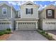 Inviting two-story home with a two-car garage and a charming brick driveway, enhancing curb appeal at 4313 Gumbo Limbo Dr, Orlando, FL 32822