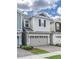 Beautiful two-story home featuring a two-car garage, complemented by lush landscaping and a well-maintained brick driveway at 4313 Gumbo Limbo Dr, Orlando, FL 32822