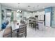 Bright kitchen features an island with seating, white cabinets, granite countertops, and stainless-steel appliances at 4313 Gumbo Limbo Dr, Orlando, FL 32822
