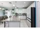 An open kitchen with white cabinets, granite countertops, stainless steel appliances, and an island with a breakfast bar at 4313 Gumbo Limbo Dr, Orlando, FL 32822