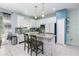Spacious kitchen features an island with seating, white cabinets, granite countertops, and stainless steel appliances at 4313 Gumbo Limbo Dr, Orlando, FL 32822