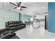 Open-concept living room with tile floors, ceiling fan, with seamless transition to the dining area and kitchen at 4313 Gumbo Limbo Dr, Orlando, FL 32822