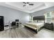 Comfortable main bedroom featuring wood floors, a tray ceiling, and ample space for a desk at 4313 Gumbo Limbo Dr, Orlando, FL 32822