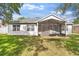 A well maintained exterior with white paint and a screened in lanai at 4520 Barrister Dr, Clermont, FL 34711