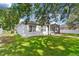 A well maintained exterior featuring an enclosed lanai and a well maintained lawn at 4520 Barrister Dr, Clermont, FL 34711