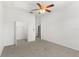 Bright bedroom featuring carpet flooring, ceiling fan, and an open closet at 4520 Barrister Dr, Clermont, FL 34711