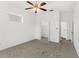 Spacious bedroom with carpeted floor, tray ceiling, closet, and neutral walls at 4520 Barrister Dr, Clermont, FL 34711