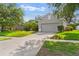 Charming home featuring a well-maintained lawn, mature trees, and a spacious driveway at 4520 Barrister Dr, Clermont, FL 34711