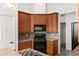 Kitchen showcasing wooden cabinets, black appliances and tile countertops at 4520 Barrister Dr, Clermont, FL 34711