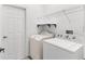Convenient laundry room featuring a washer, dryer, and storage at 4520 Barrister Dr, Clermont, FL 34711