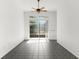 Bright living room with tile flooring and a sliding glass door to the backyard at 4520 Barrister Dr, Clermont, FL 34711