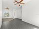 Open living room with tile flooring, ceiling fans, and natural light from a large window at 4520 Barrister Dr, Clermont, FL 34711