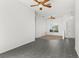 Bright living area with tile flooring, ceiling fans, and views of the front entrance at 4520 Barrister Dr, Clermont, FL 34711