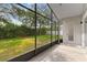 A backyard with a screened in lanai, with a beautiful view of the lawn and garden at 4520 Barrister Dr, Clermont, FL 34711
