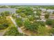 Beautiful aerial view of neighborhood homes and lake with city skyline in the distance at 490 Shoreview Ave, Winter Park, FL 32789