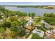 Beautiful aerial view of neighborhood homes and lake with city skyline in the distance at 490 Shoreview Ave, Winter Park, FL 32789