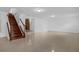 Spacious basement area with stairs, tile floors, and a brick fireplace at 490 Shoreview Ave, Winter Park, FL 32789