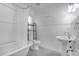 Bright bathroom featuring a clawfoot tub and a pedestal sink with stylish fixtures, showcasing a classic design at 490 Shoreview Ave, Winter Park, FL 32789