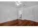 Bright bedroom features hardwood floors, white walls, ceiling fan and closet at 490 Shoreview Ave, Winter Park, FL 32789