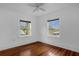 Bright bedroom featuring hardwood floors, two windows, and ceiling fan, creating a cozy atmosphere at 490 Shoreview Ave, Winter Park, FL 32789