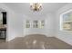 Bright dining room featuring neutral walls, tile flooring, bay windows and chandelier at 490 Shoreview Ave, Winter Park, FL 32789