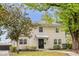 Charming two-story home with black front door, manicured landscaping and mature trees at 490 Shoreview Ave, Winter Park, FL 32789