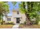 Charming two-story home with black front door, manicured landscaping and mature trees at 490 Shoreview Ave, Winter Park, FL 32789