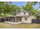 Backyard view of the house featuring a screened-in porch and private yard at 490 Shoreview Ave, Winter Park, FL 32789
