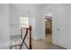 Hallway with stairs, wood trim, and tile floors, offering a view into another bathroom with a glass shower at 490 Shoreview Ave, Winter Park, FL 32789