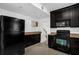 Charming kitchen with black appliances, granite countertops, and tile floors at 490 Shoreview Ave, Winter Park, FL 32789