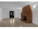 Bright living room featuring brick fireplace, neutral walls, and tile flooring at 490 Shoreview Ave, Winter Park, FL 32789
