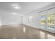 Large living room with tile flooring, bright windows, and glass patio doors at 490 Shoreview Ave, Winter Park, FL 32789