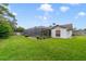 Lush backyard featuring a well-maintained lawn and a screened-in pool area, perfect for outdoor activities and relaxation at 513 Sabal Trail Cir, Longwood, FL 32779