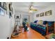 Well-lit bedroom featuring wood floors, ceiling fan, and a daybed, creating a versatile and comfortable living space at 513 Sabal Trail Cir, Longwood, FL 32779