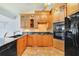 Well-equipped kitchen features custom cabinets, tile backsplash, and modern appliances at 513 Sabal Trail Cir, Longwood, FL 32779