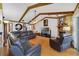 Inviting living room with a brick fireplace, exposed beams, and comfortable seating at 513 Sabal Trail Cir, Longwood, FL 32779