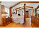 Spacious main bedroom with wood floors, vaulted ceilings with wood beams, and a four-poster bed with decorative textiles at 513 Sabal Trail Cir, Longwood, FL 32779