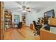 Home office with hardwood floors, ceiling fan, built-in bookshelves, and desk space, offering a functional workspace at 513 Sabal Trail Cir, Longwood, FL 32779
