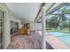 Covered outdoor patio with brick flooring, a ceiling fan, and a view of the screened-in pool area, perfect for relaxation at 513 Sabal Trail Cir, Longwood, FL 32779