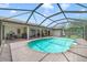 Outdoor pool with a screened-in enclosure and brick patio, providing an ideal space for recreation and relaxation at 513 Sabal Trail Cir, Longwood, FL 32779