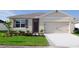 Charming single-story home featuring a two-car garage, well-manicured lawn, and neatly landscaped front yard at 5145 Masser Rd, St Cloud, FL 34772